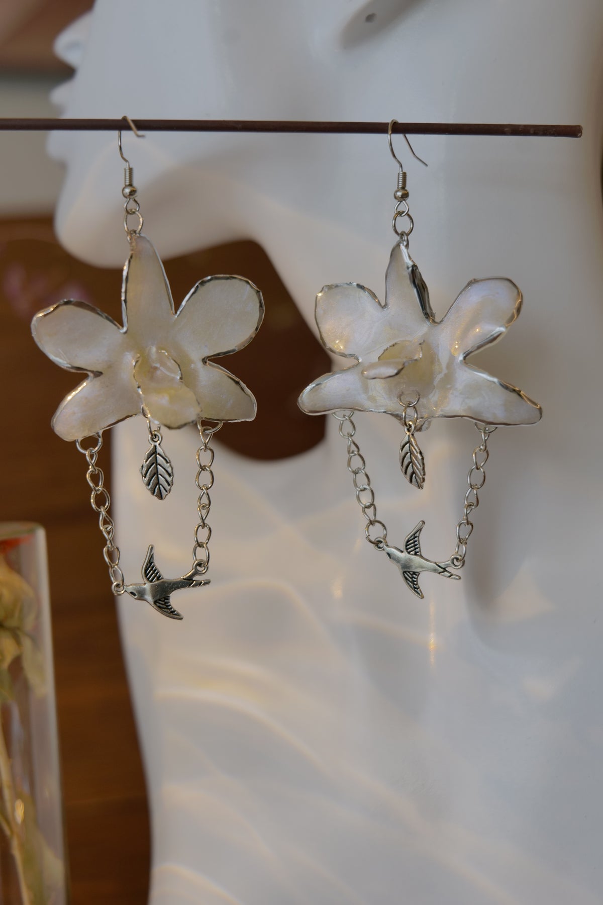 ALBION — White Dendrobium Bird Dangle Earrings by Terra Decode — product photograph 4 showing the handmade botanical earrings.