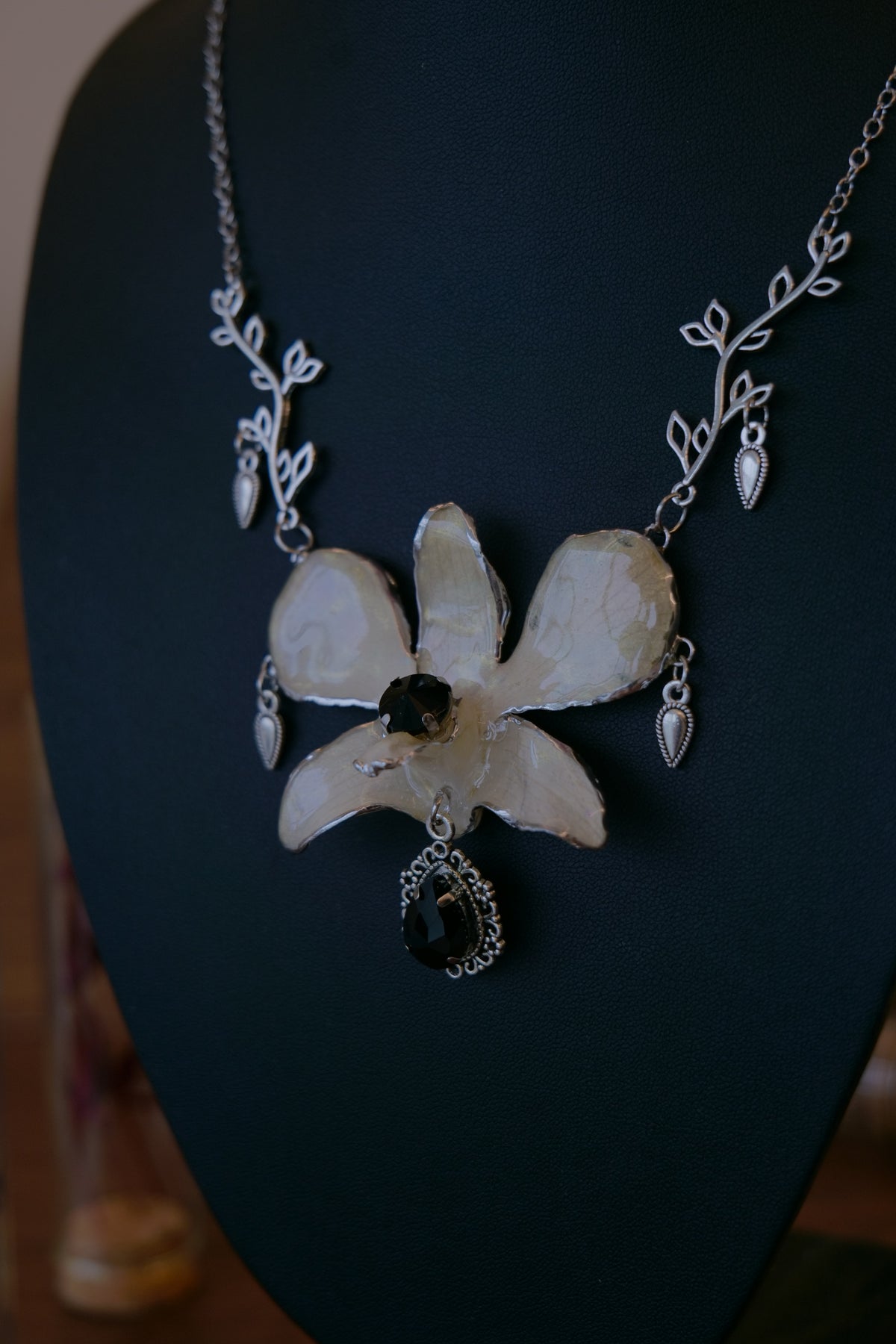 NOCTURNE — White Dendrobium Black Crystal Vintage Pendant Necklace by Terra Decode — product photograph 3 showing the handmade necklace and botanical details.