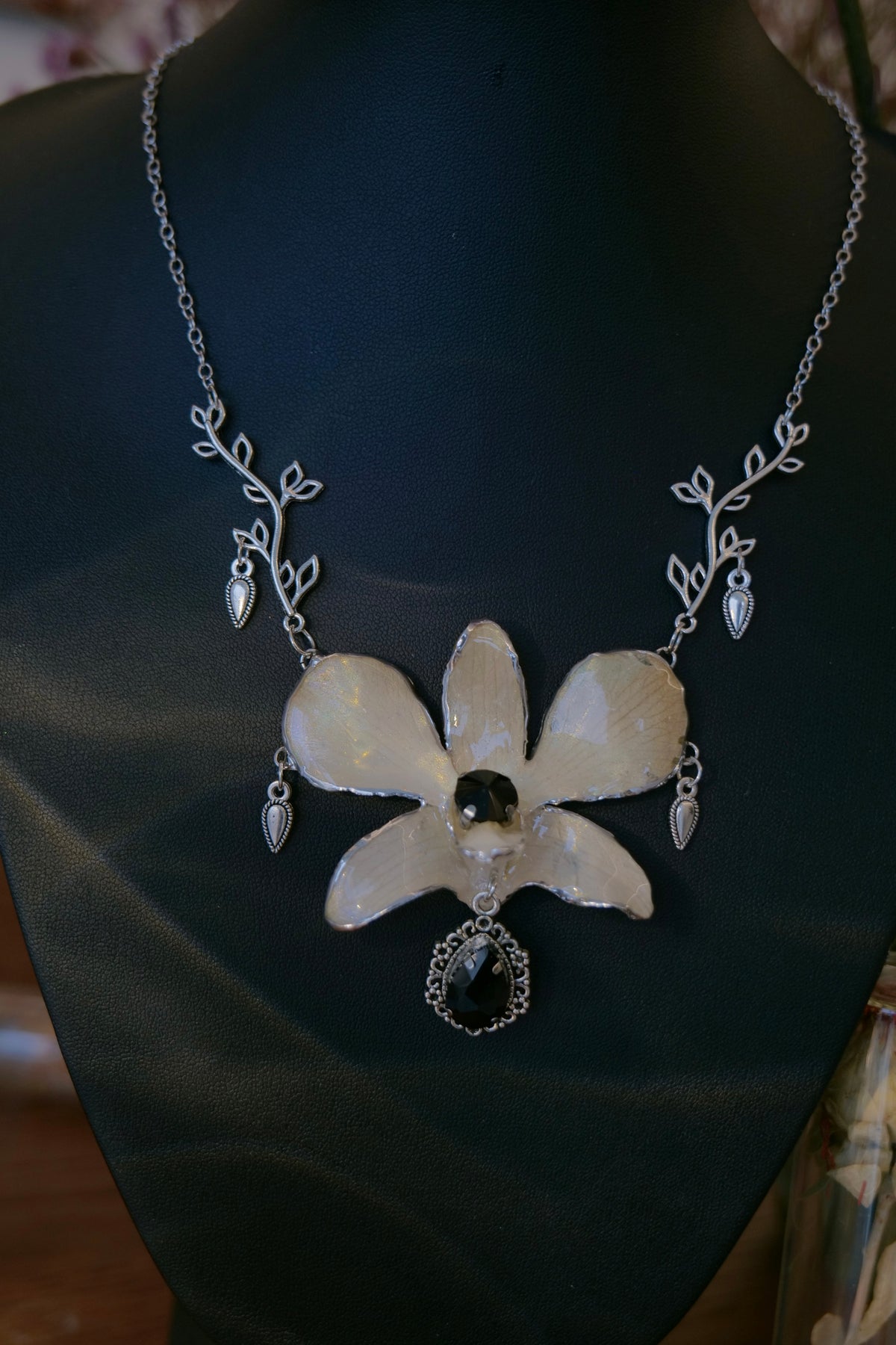 NOCTURNE — White Dendrobium Black Crystal Vintage Pendant Necklace by Terra Decode — product photograph 4 showing the handmade necklace and botanical details.