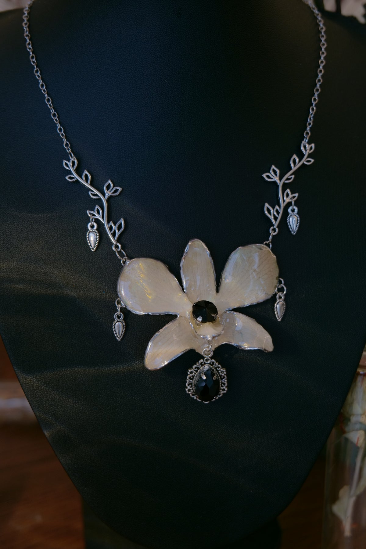 NOCTURNE — White Dendrobium Black Crystal Vintage Pendant Necklace by Terra Decode — product photograph 5 showing the handmade necklace and botanical details.