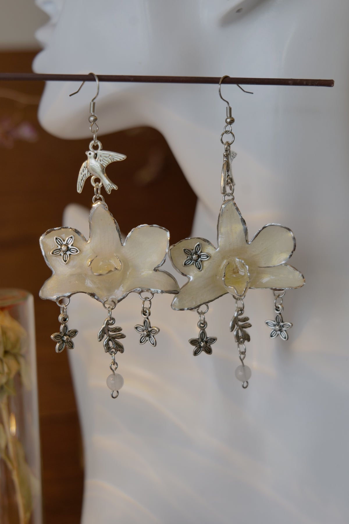 AURORA — White Dendrobium Flower & Bird Dangle Earrings by Terra Decode — product photograph 1 showing the handmade botanical earrings.