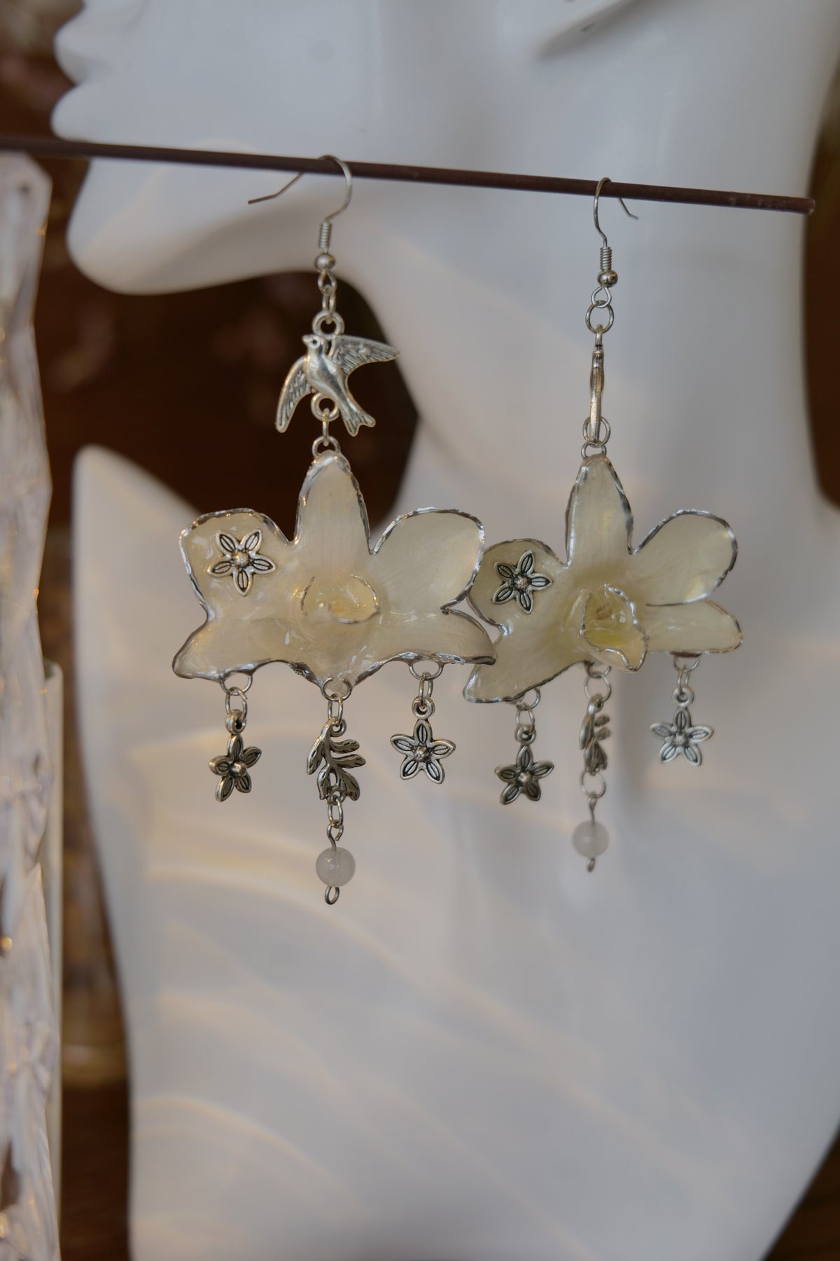 AURORA — White Dendrobium Flower & Bird Dangle Earrings by Terra Decode — product photograph 2 showing the handmade botanical earrings.