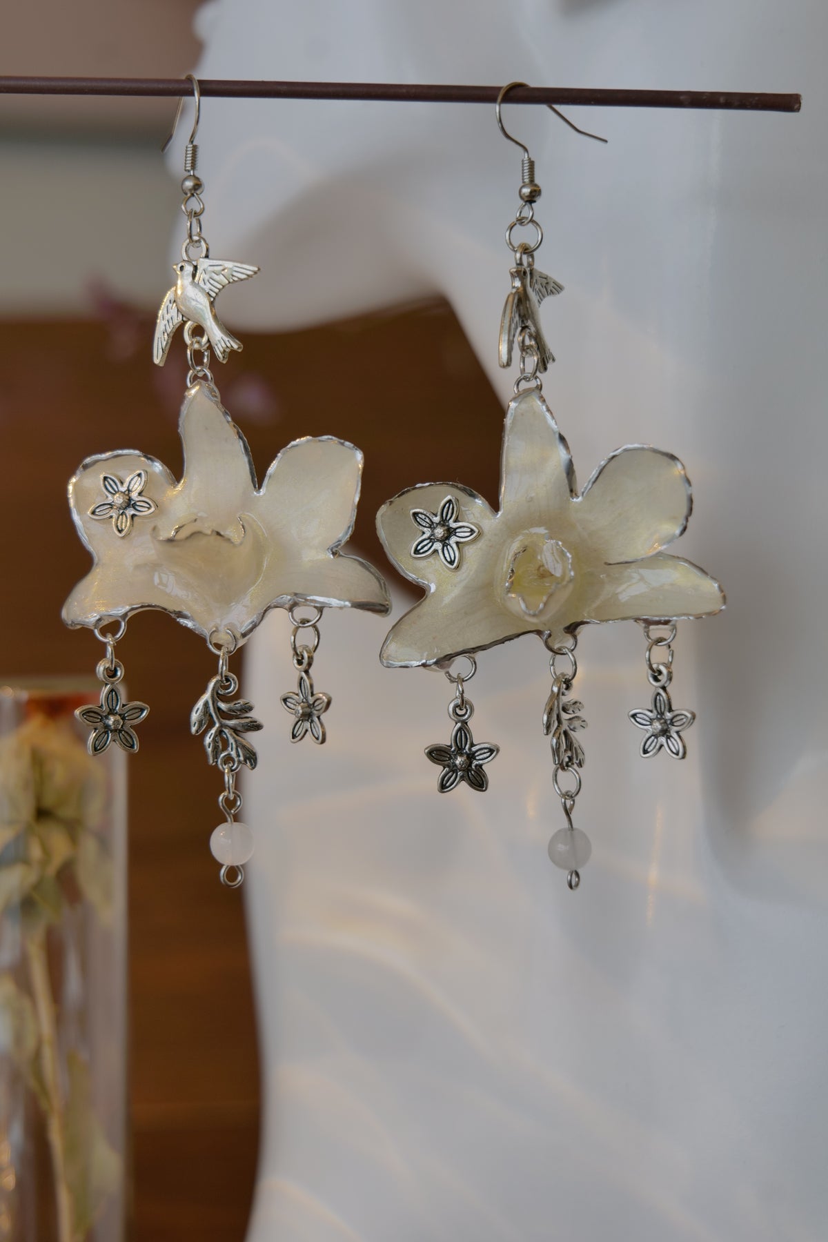 AURORA — White Dendrobium Flower & Bird Dangle Earrings by Terra Decode — product photograph 3 showing the handmade botanical earrings.