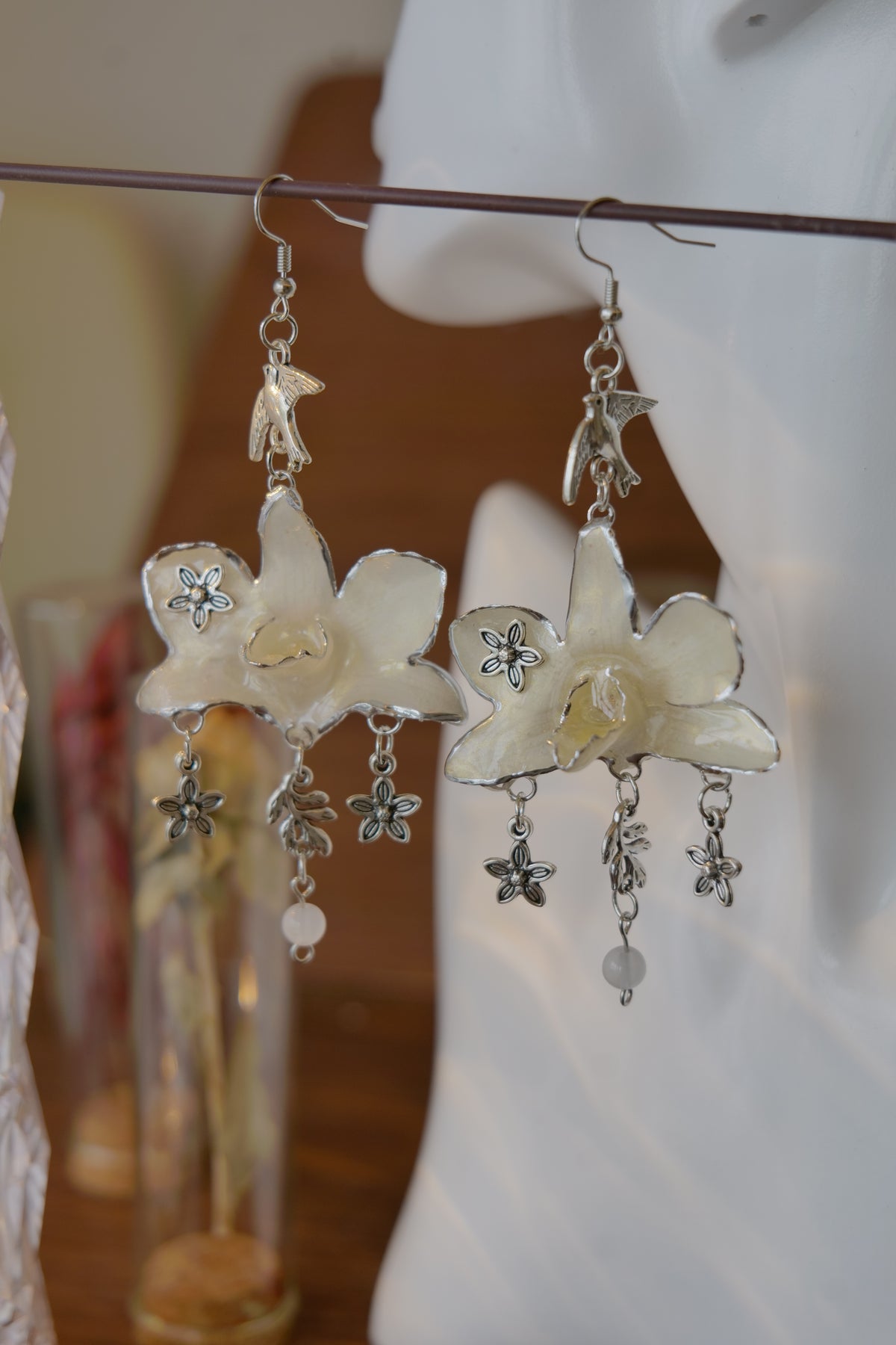 AURORA — White Dendrobium Flower & Bird Dangle Earrings by Terra Decode — product photograph 5 showing the handmade botanical earrings.
