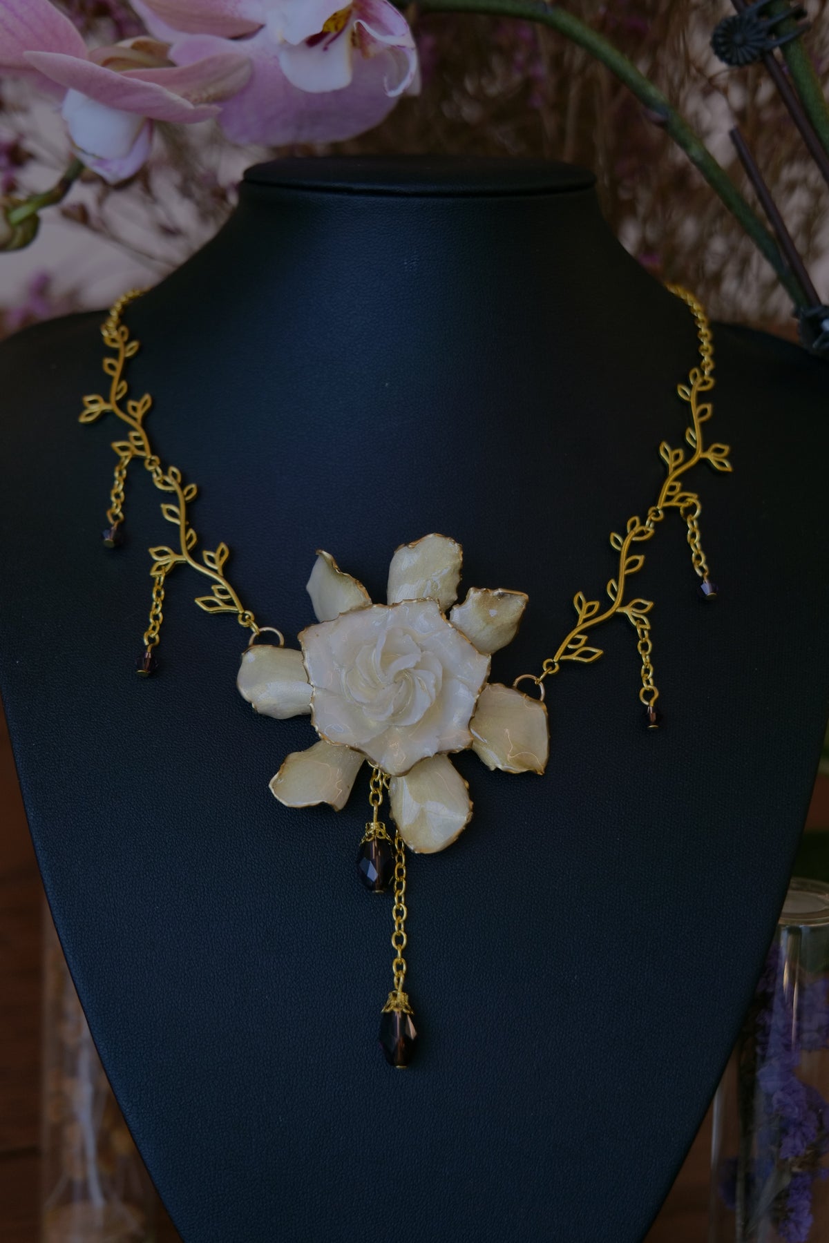 AMETHYSTA — Gardenia Gold Leaf Purple Crystal Pendant Necklace by Terra Decode — product photograph 1 showing the handmade necklace and botanical details.