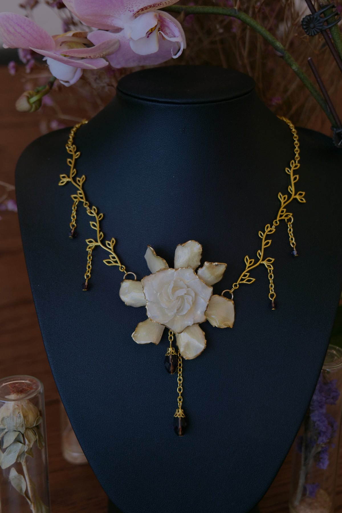 AMETHYSTA — Gardenia Gold Leaf Purple Crystal Pendant Necklace by Terra Decode — product photograph 4 showing the handmade necklace and botanical details.