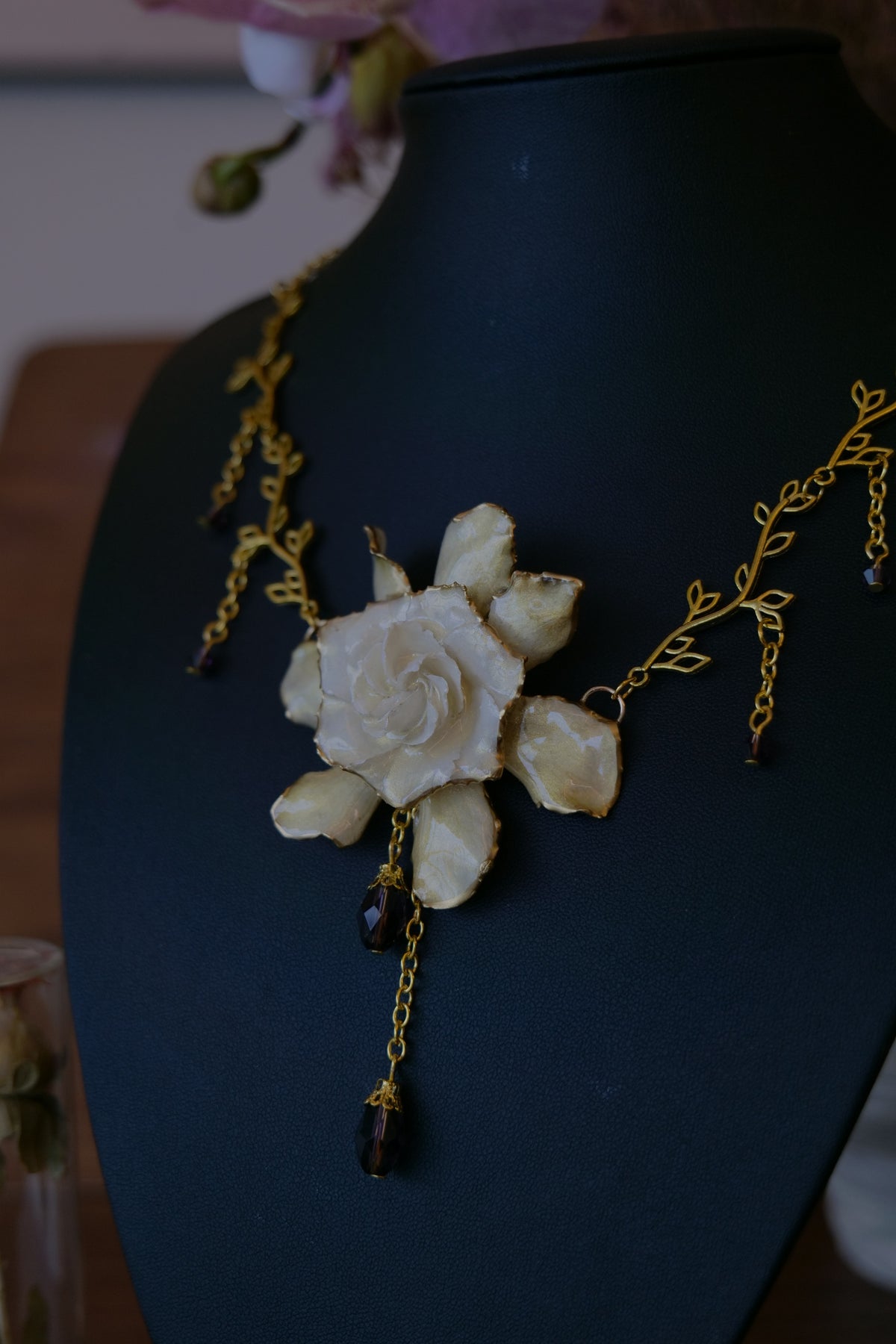 AMETHYSTA — Gardenia Gold Leaf Purple Crystal Pendant Necklace by Terra Decode — product photograph 5 showing the handmade necklace and botanical details.