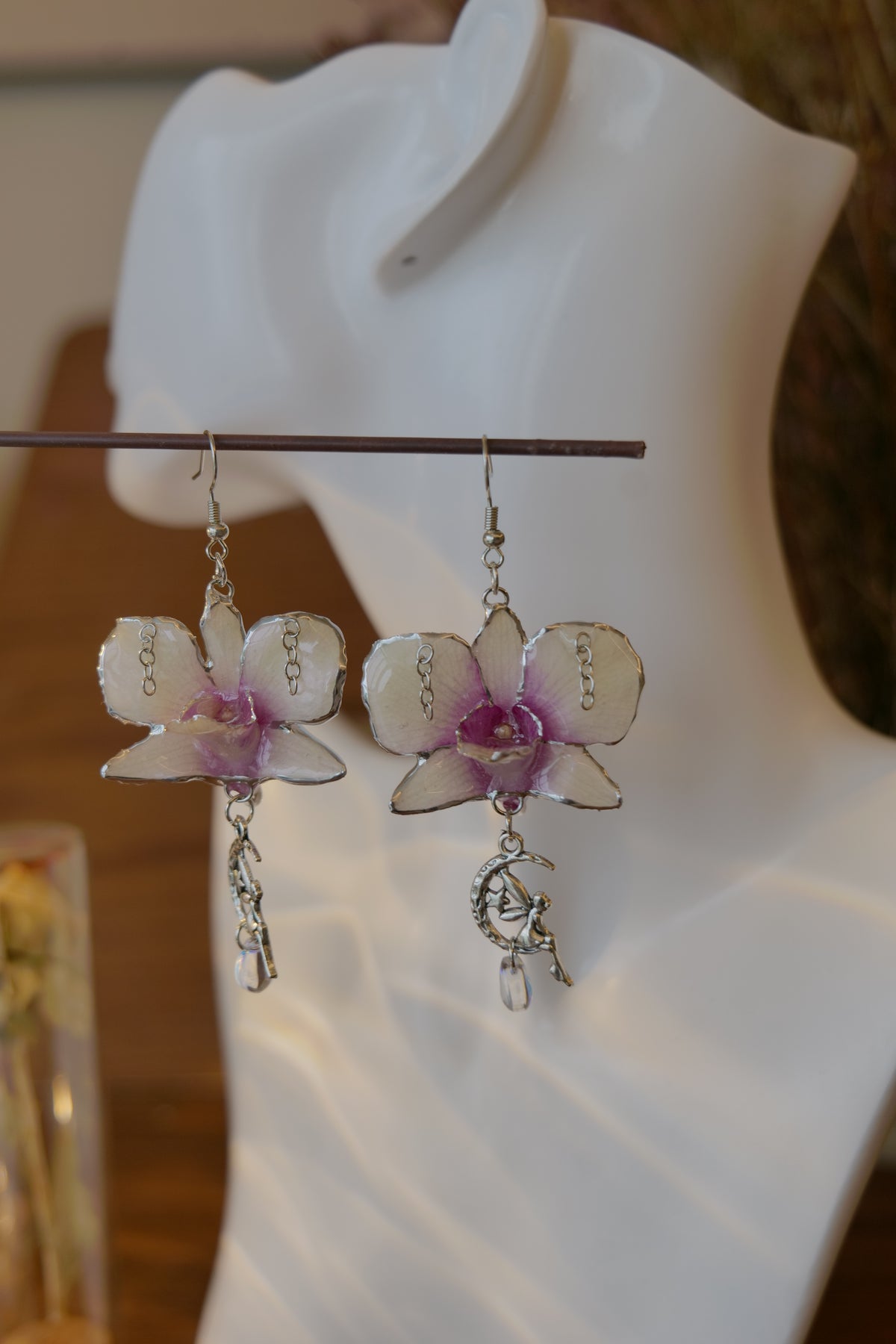 SERAPHIEL — Dendrobium Angel Charm Colour-Shift Earrings by Terra Decode — product photograph 2 showing the handmade botanical earrings.
