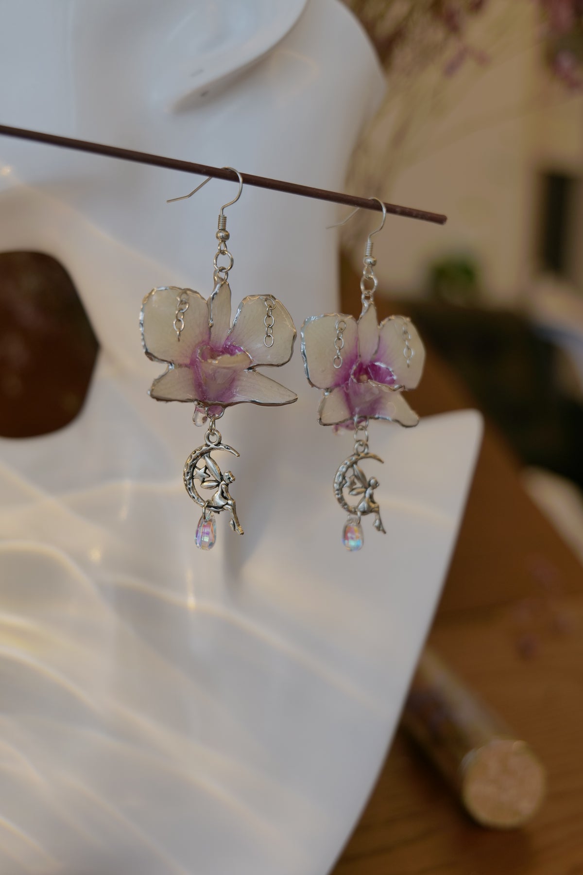 SERAPHIEL — Dendrobium Angel Charm Colour-Shift Earrings by Terra Decode — product photograph 4 showing the handmade botanical earrings.