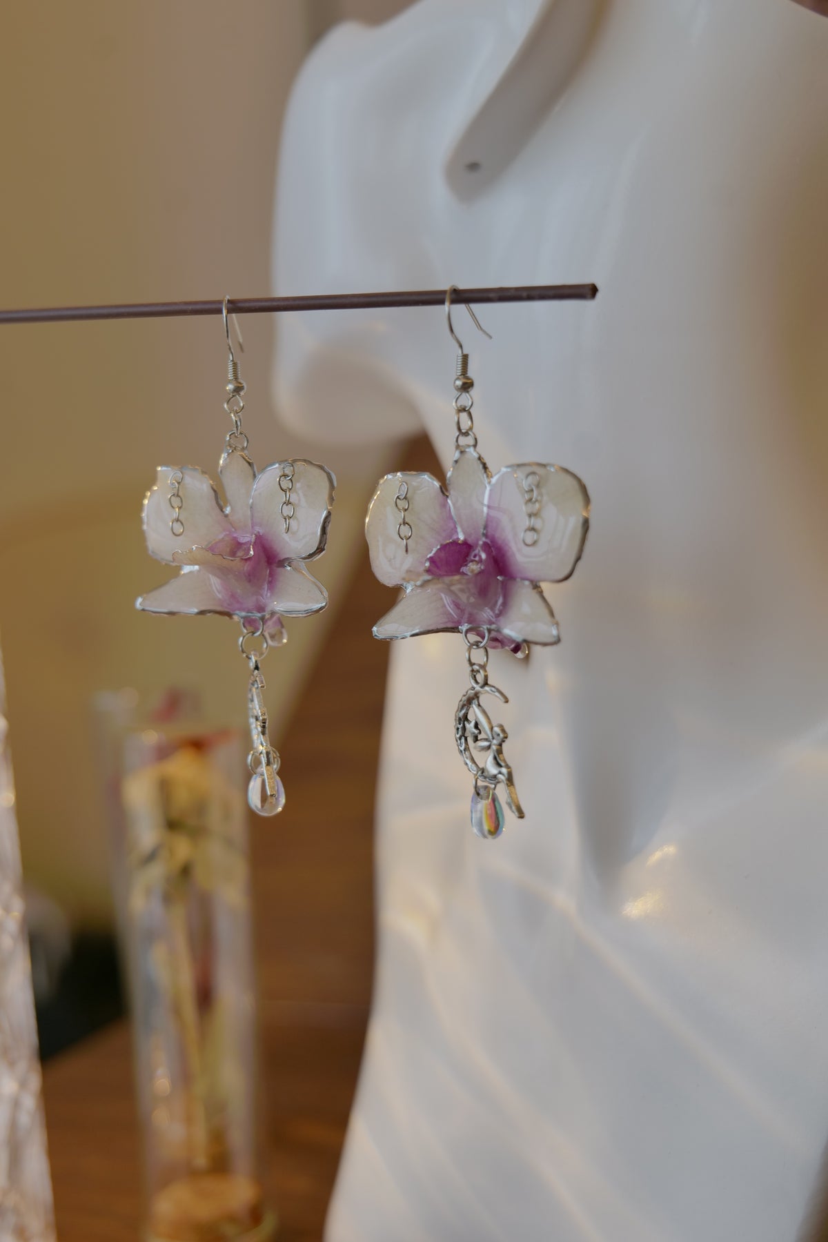 SERAPHIEL — Dendrobium Angel Charm Colour-Shift Earrings by Terra Decode — product photograph 5 showing the handmade botanical earrings.