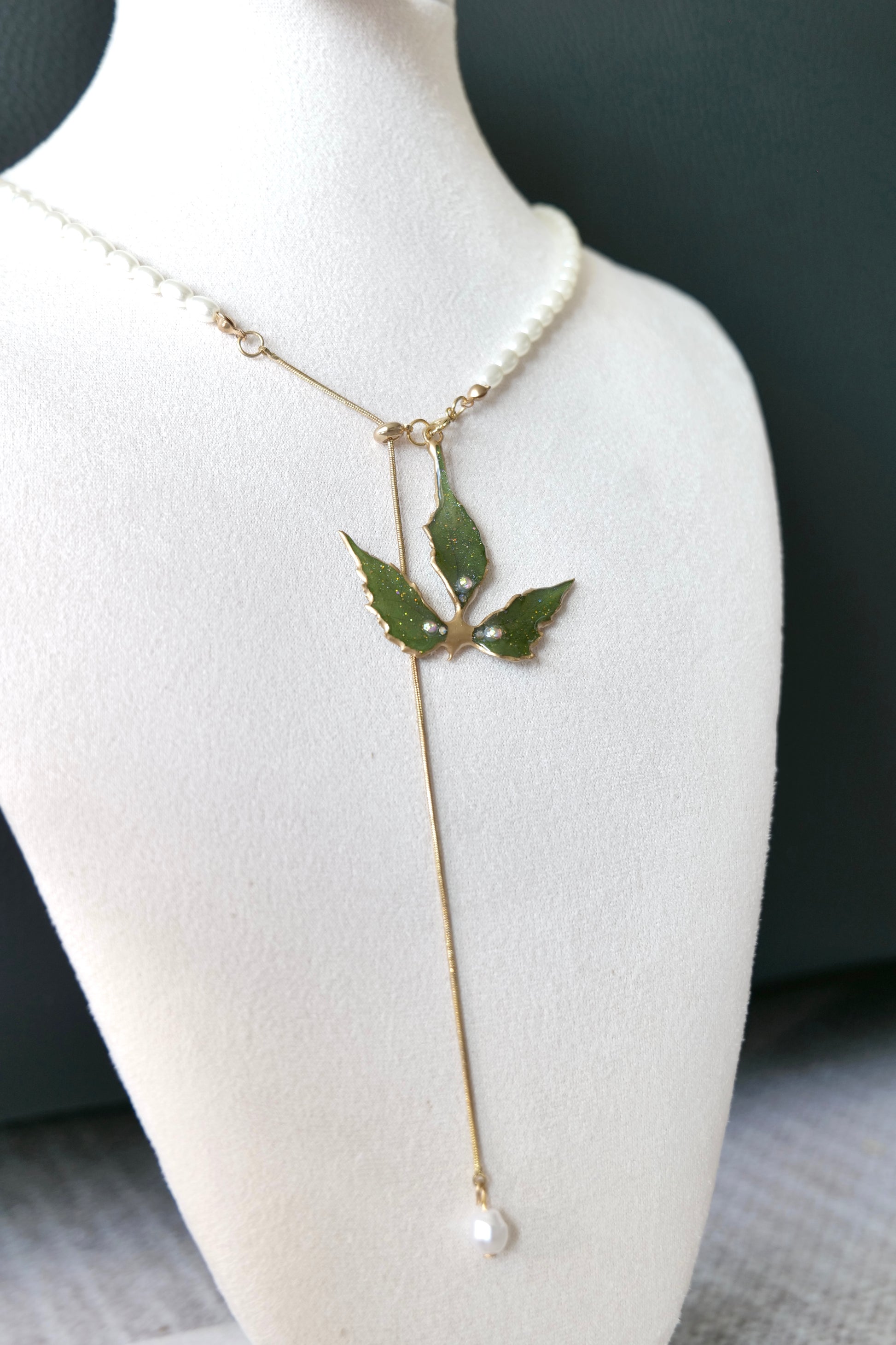 Close-up of Boston ivy leaf veins, gold-toned details and three crystal-style accents