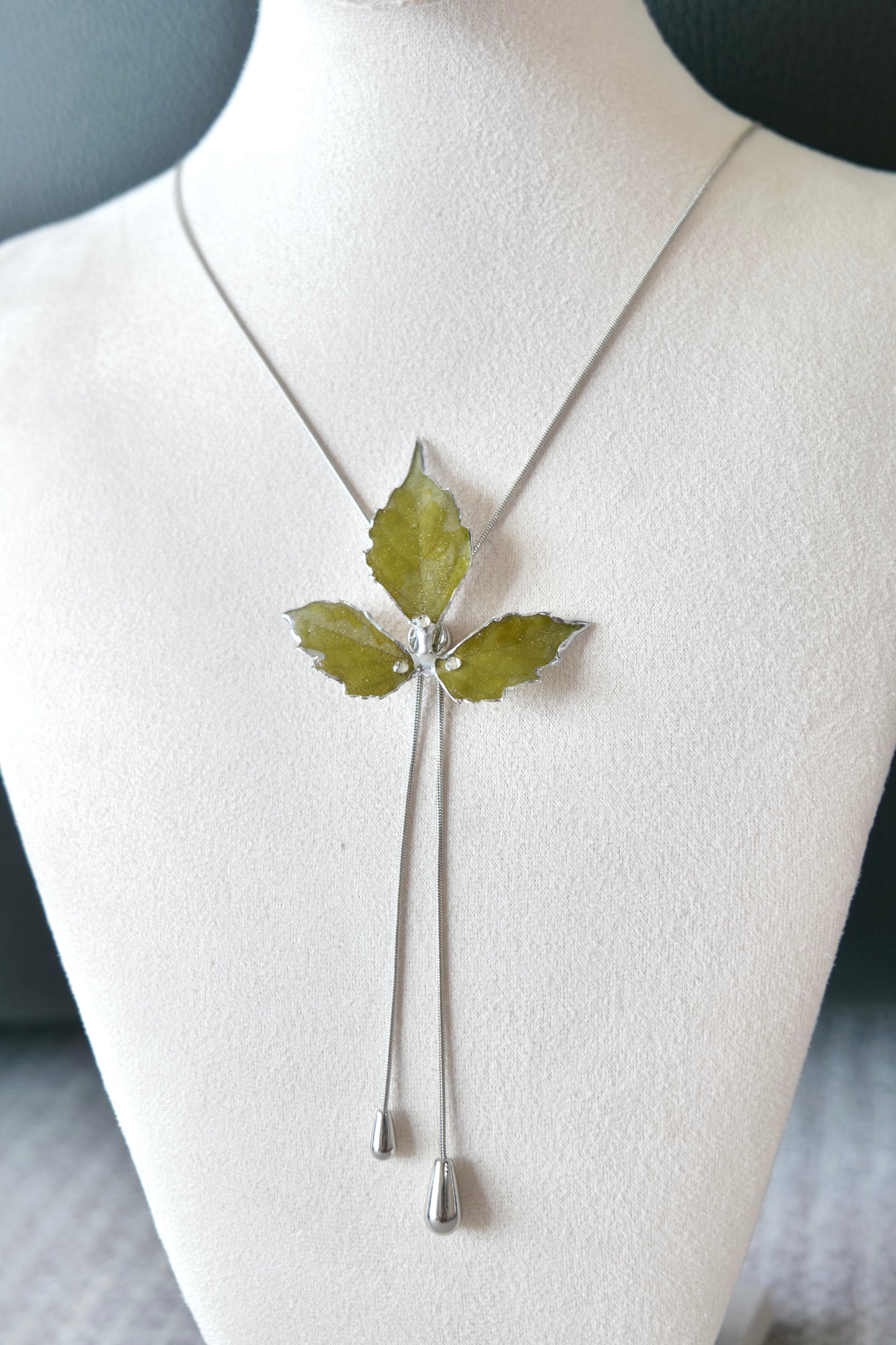 Full-length alternative view of the silver three-leaf twin-drop lariat necklace by Terra Decode
