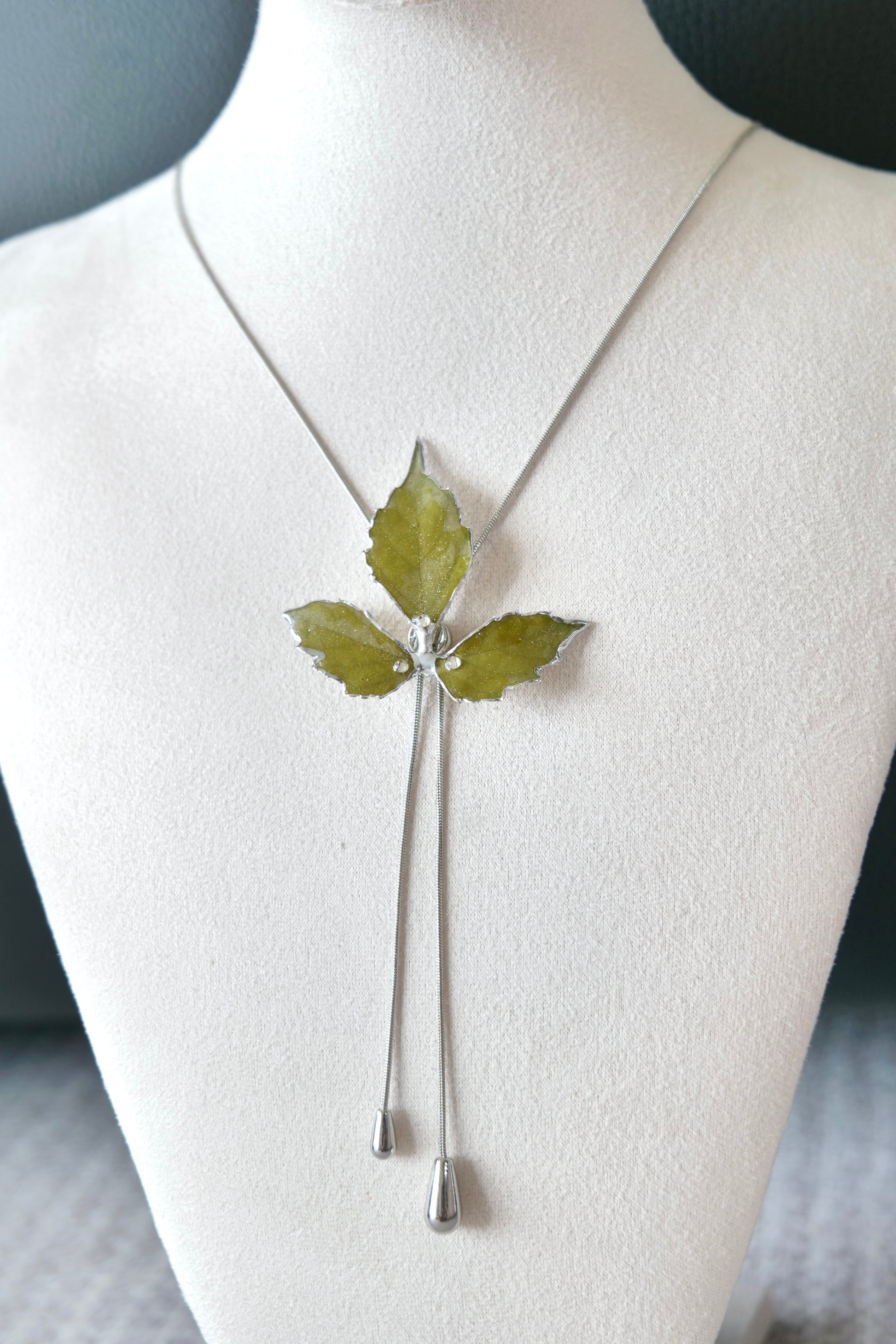 Full-length alternative view of the silver three-leaf twin-drop lariat necklace by Terra Decode