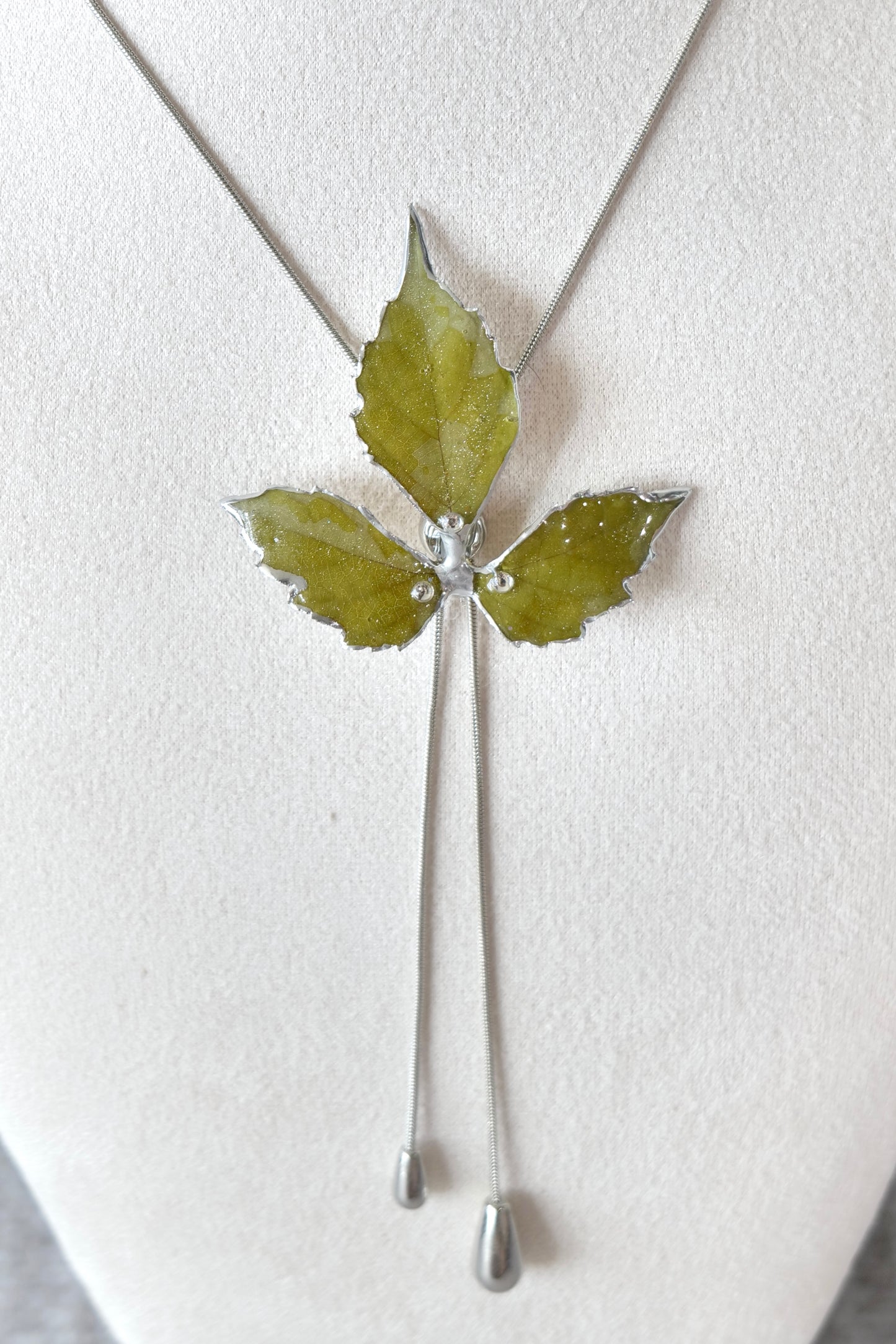 Silver-toned lariat chain and polished alloy metal detail