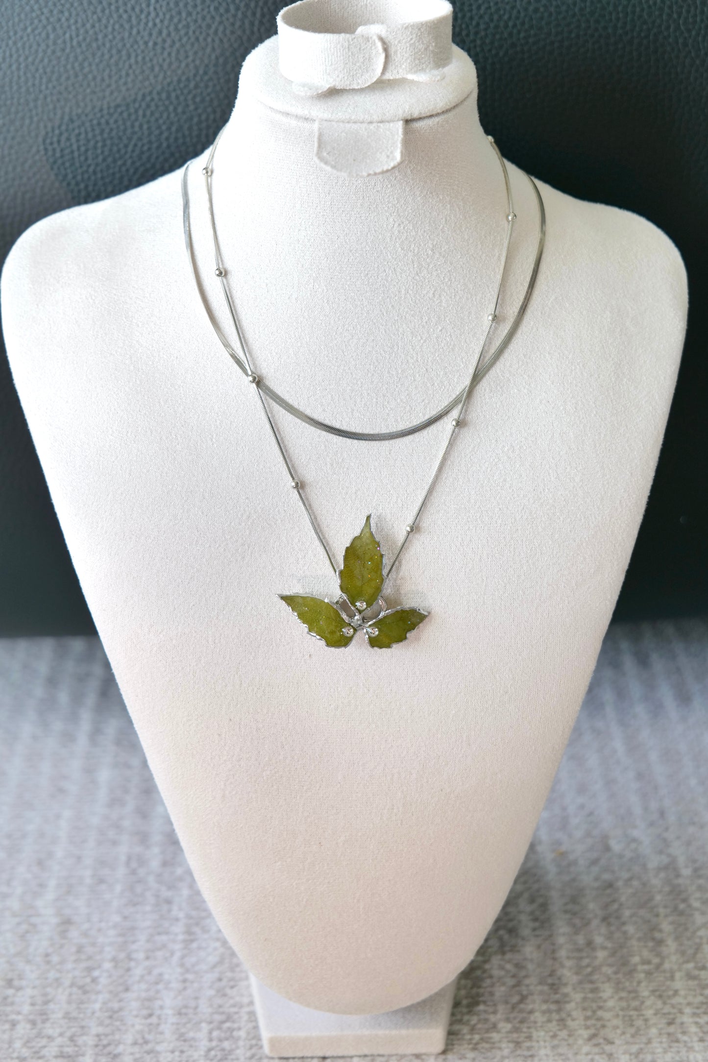 Full front view of the layered silver three-leaf botanical necklace by Terra Decode