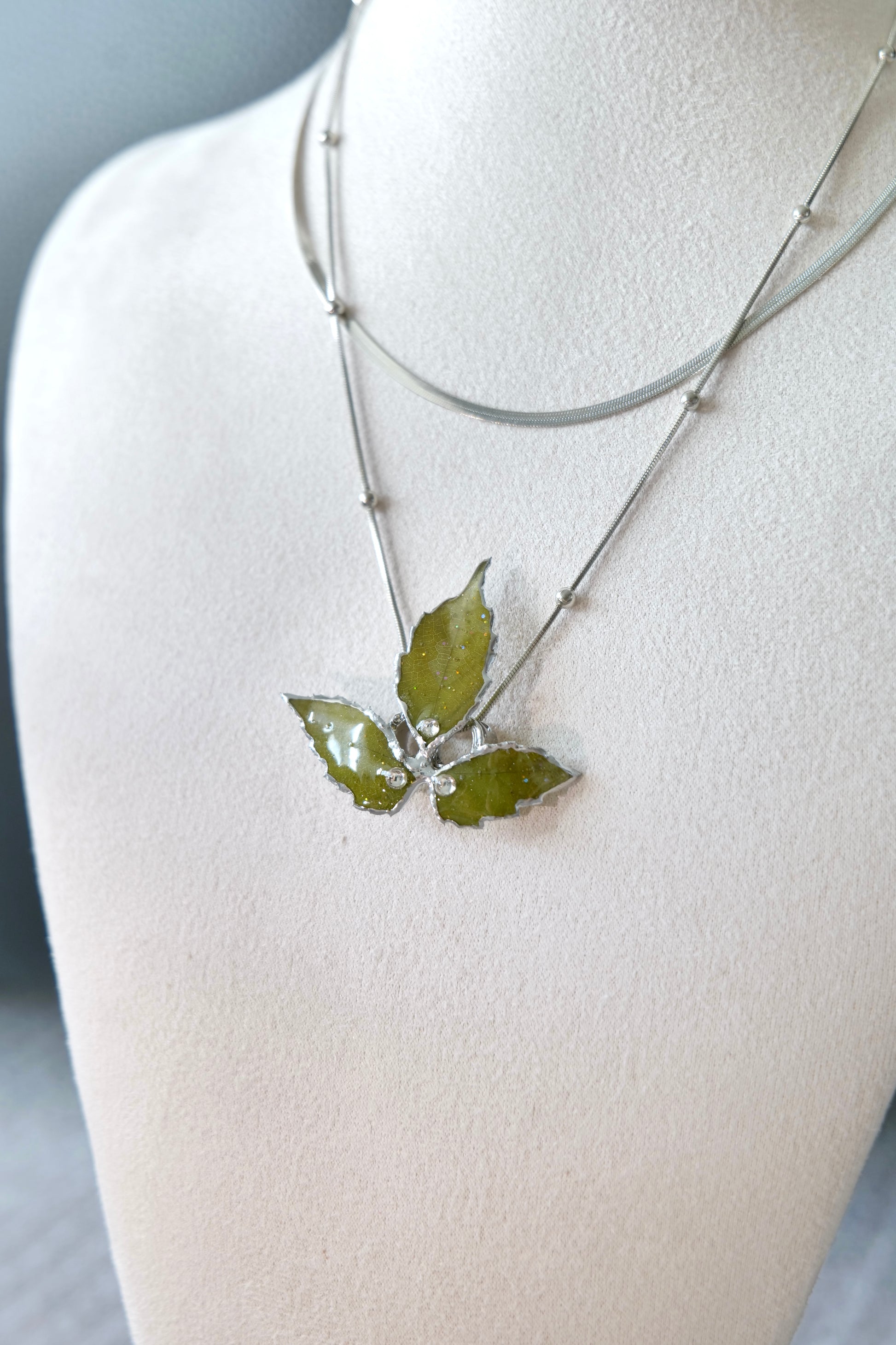 Layered silver-toned chain construction with polished alloy metal beads