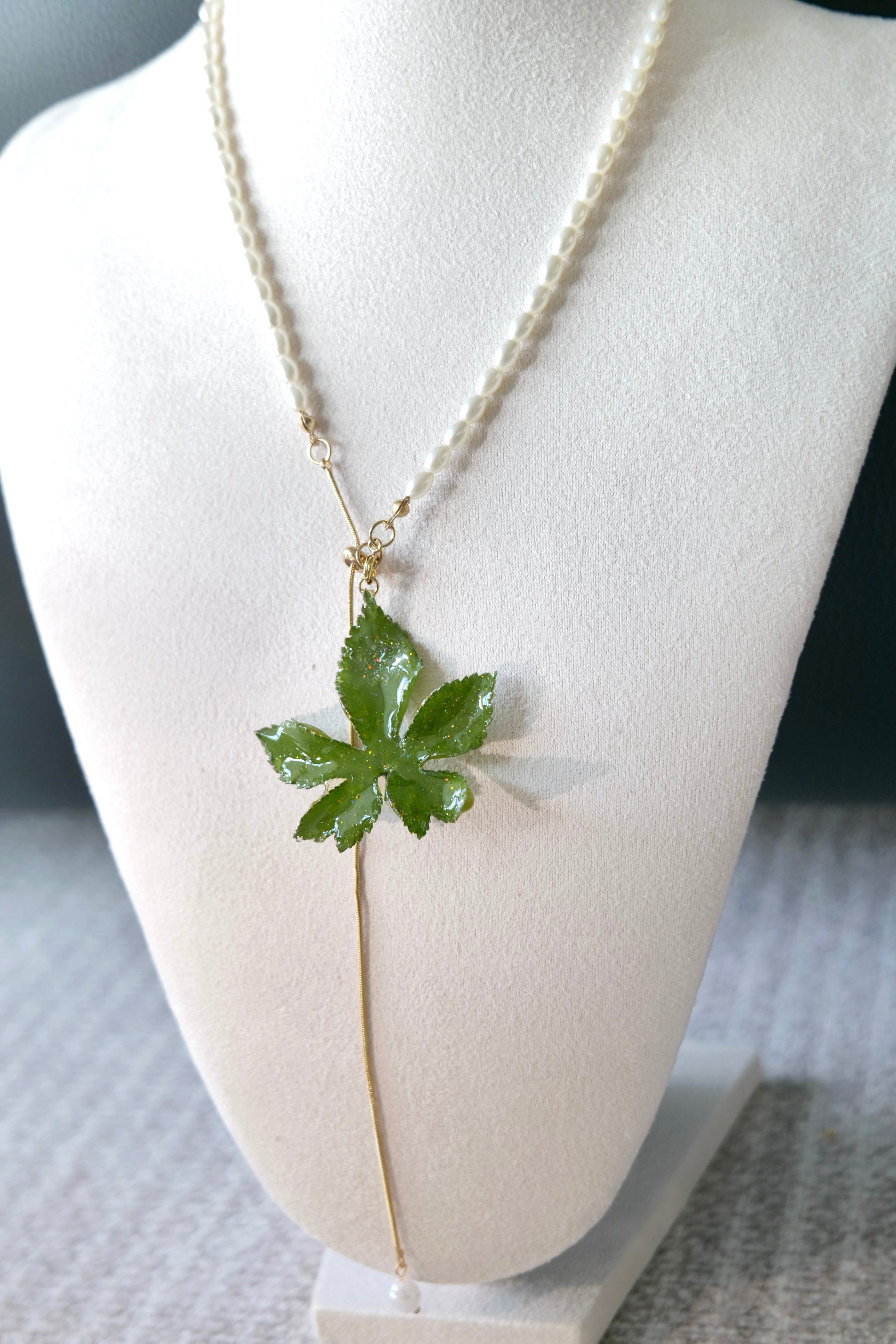 Angled view of the preserved Japanese hop pendant and pull-through chain