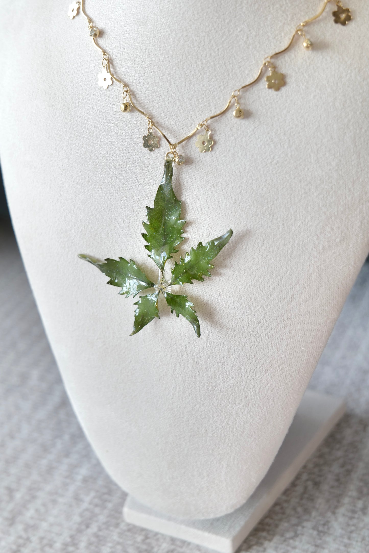 Gold-toned chain detail with small alloy metal floral charms