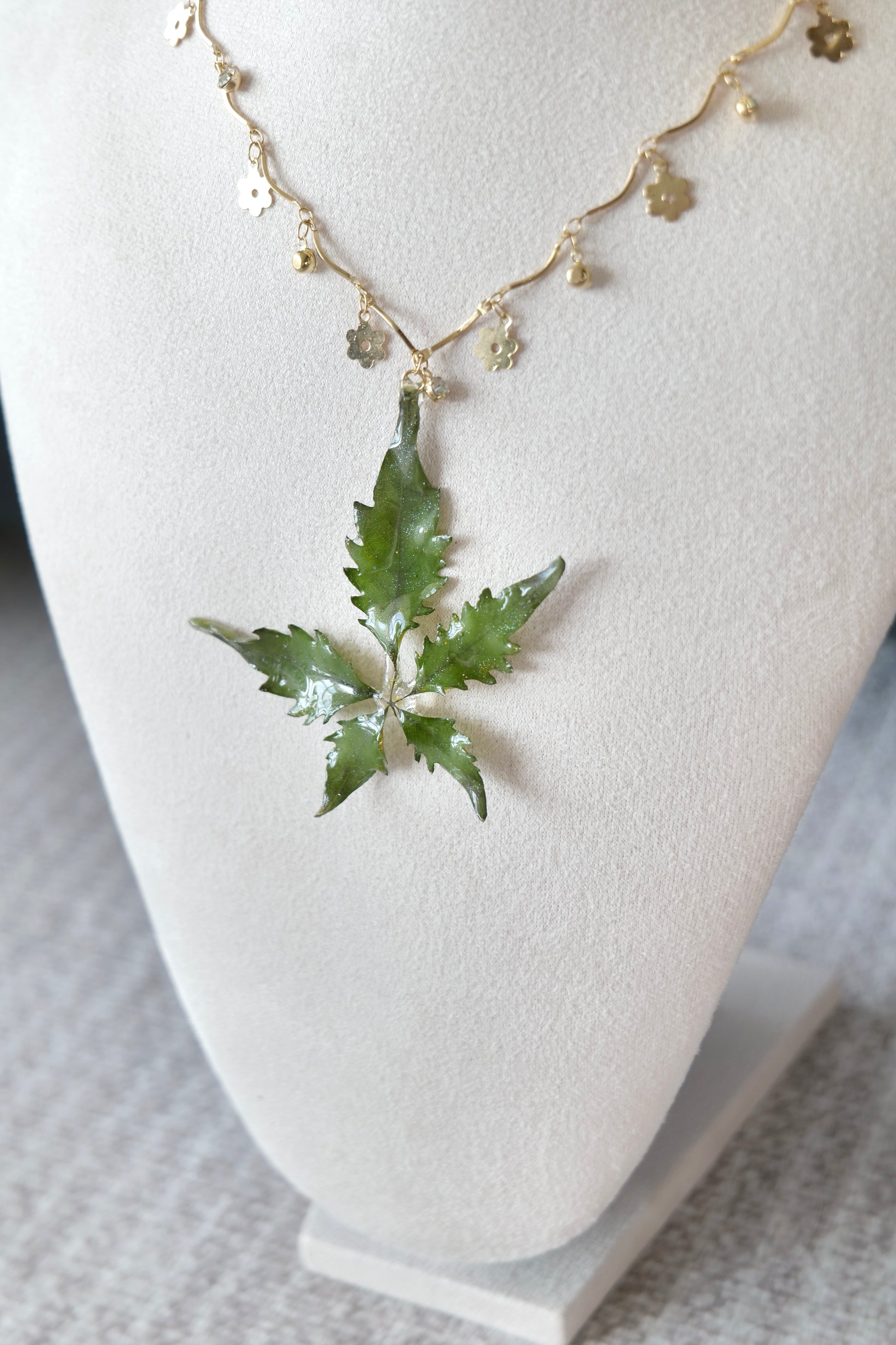 Gold-toned chain detail with small alloy metal floral charms