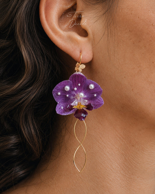 Purple orchid earrings with resin petals and fine gold-tone tassel details by Terra Decode