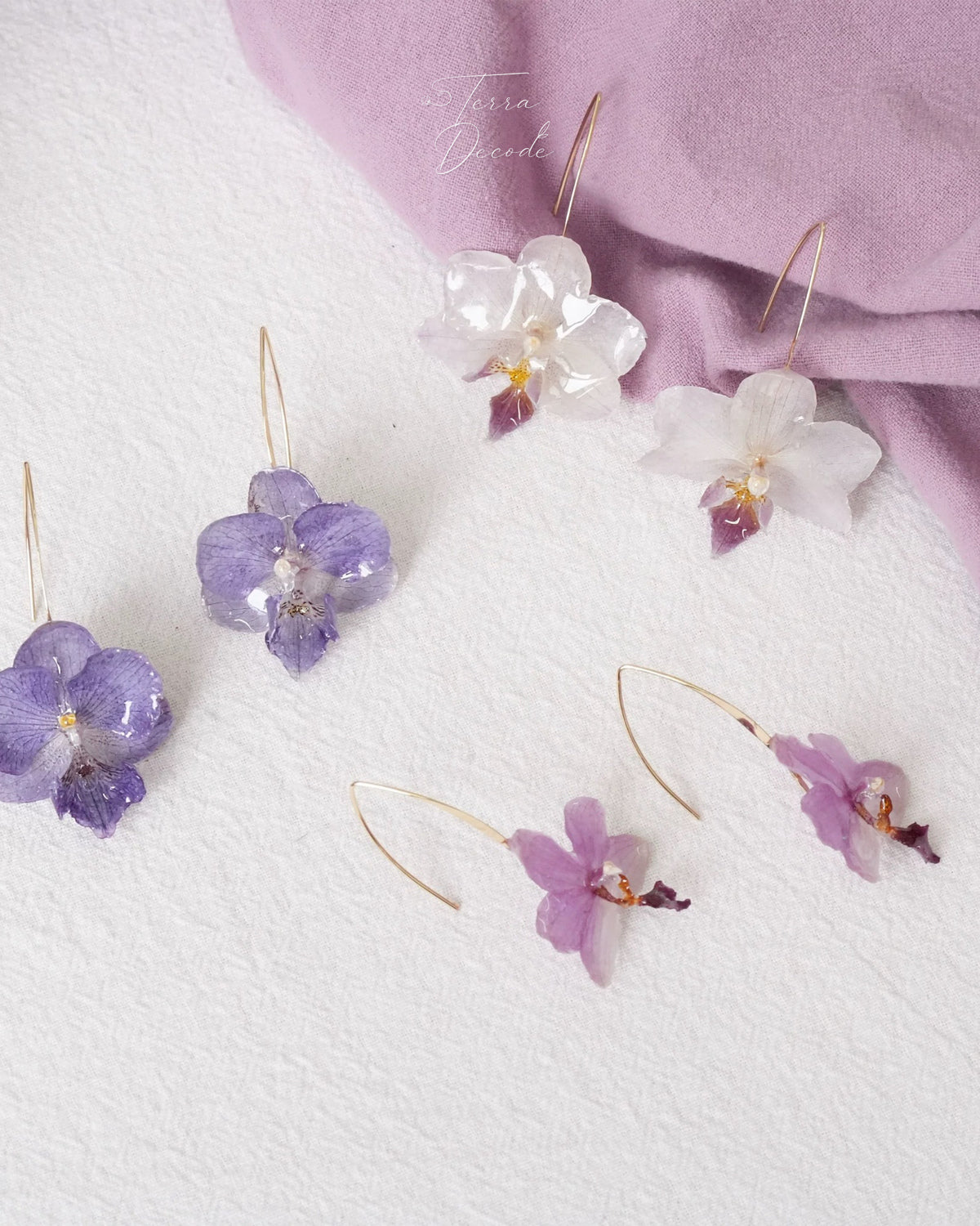 Orchid ear hook earring variations with cream white, blue lavender and soft pink resin petals by Terra Decode