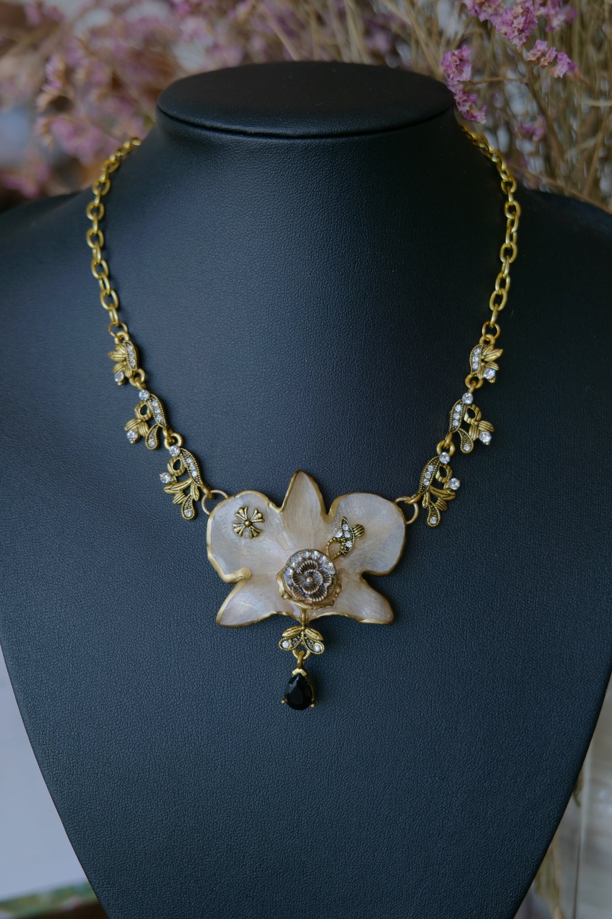 Styled view of Victorian-inspired white orchid necklace with crystal accents