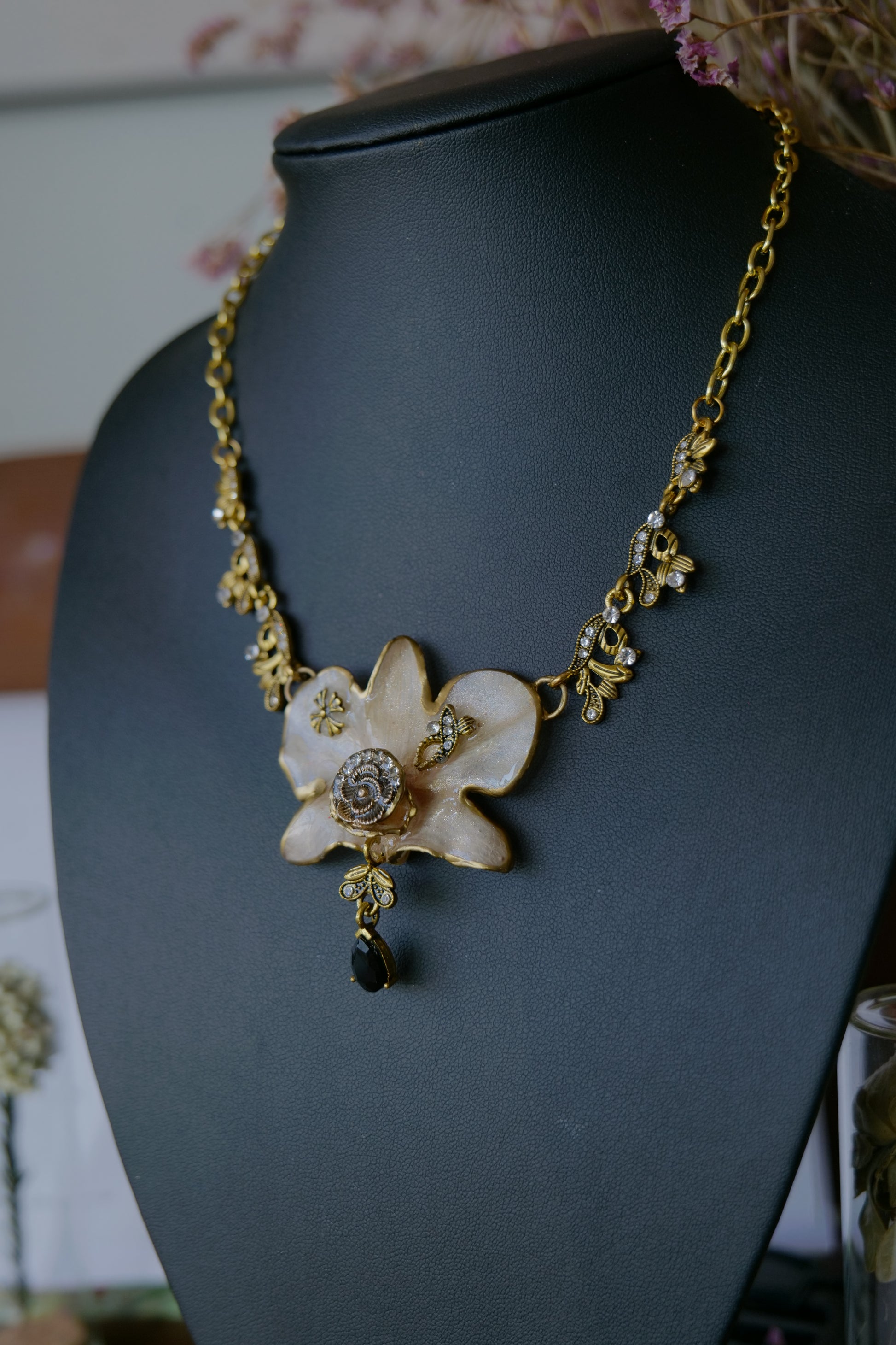 Side view of the preserved white orchid and ornate statement setting