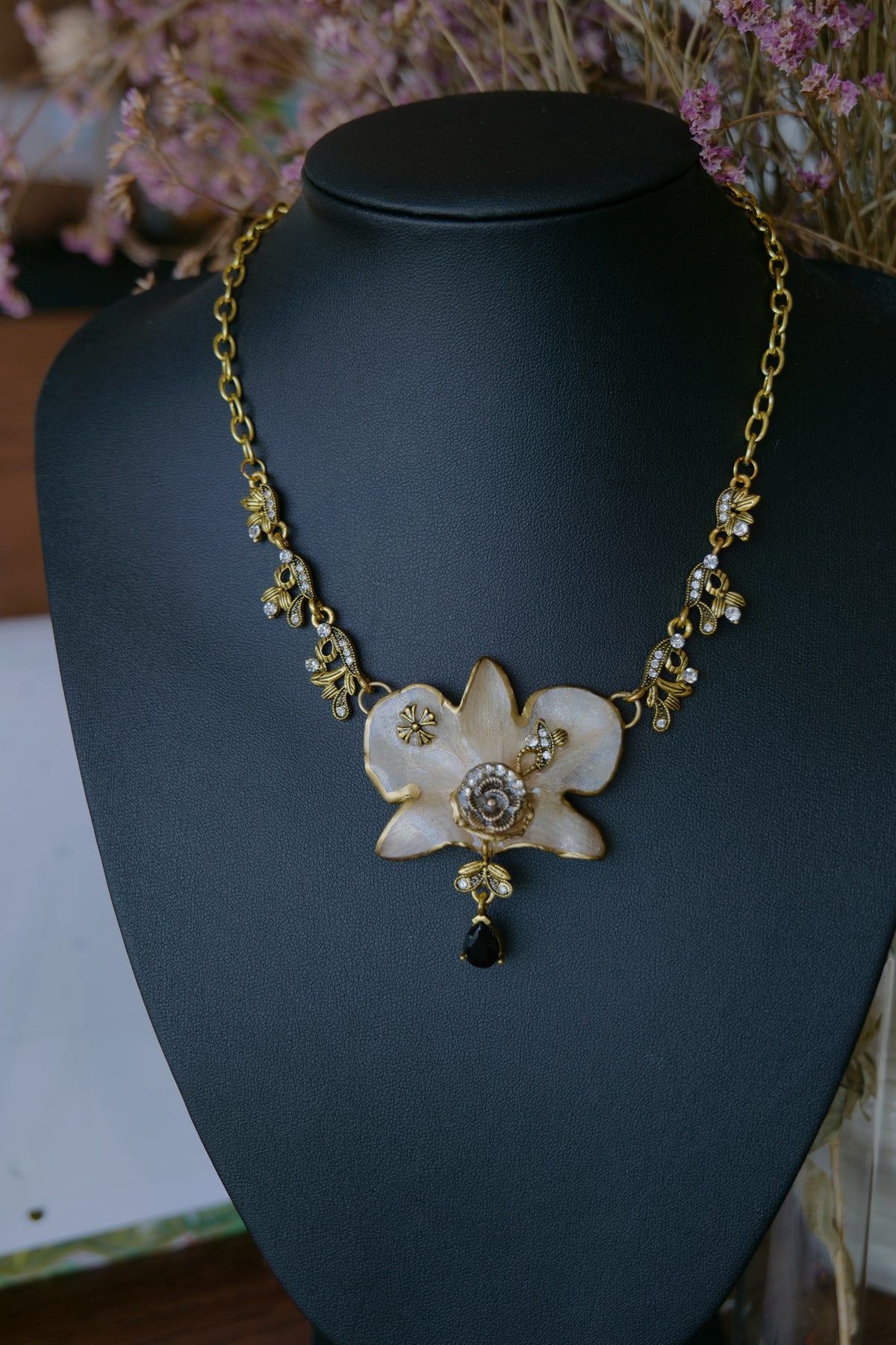 Back and fastening detail of the handmade white orchid necklace