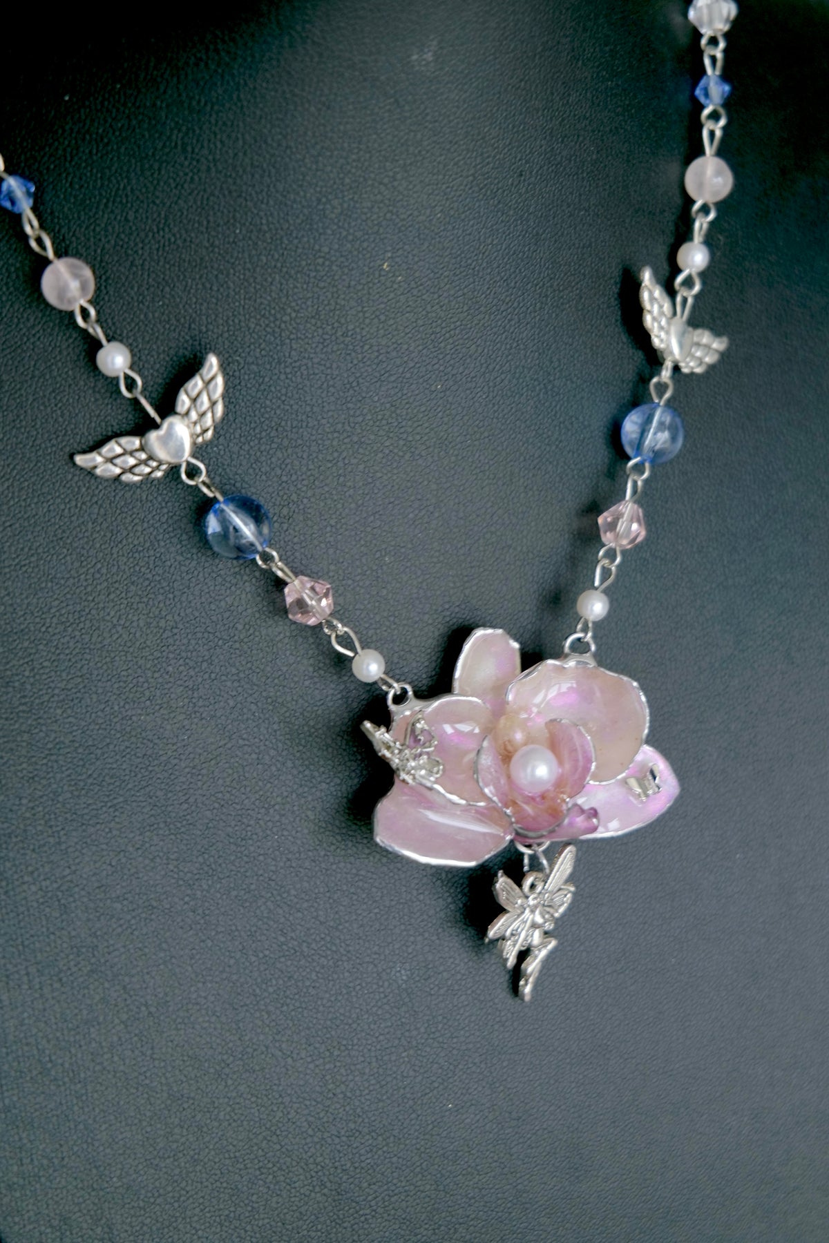 Pink preserved Phalaenopsis orchid angel pendant necklace with silver wings, pearls and pastel Y2K beads.
