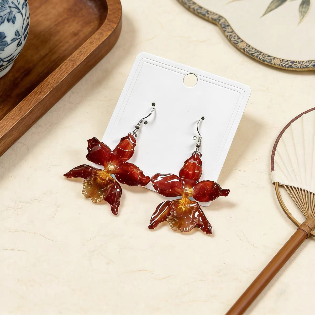 Crimson orchid earrings with resin flower petals and silver-tone hooks by Terra Decode