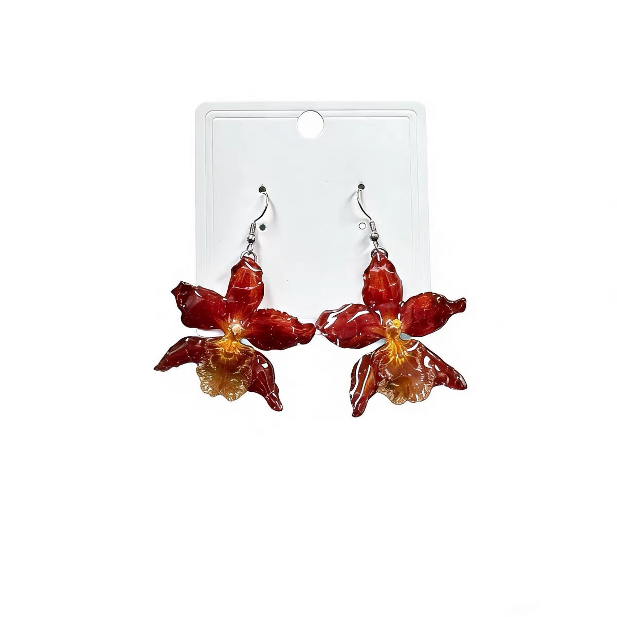 Crimson orchid drop earrings with resin petals on a jewellery card by Terra Decode