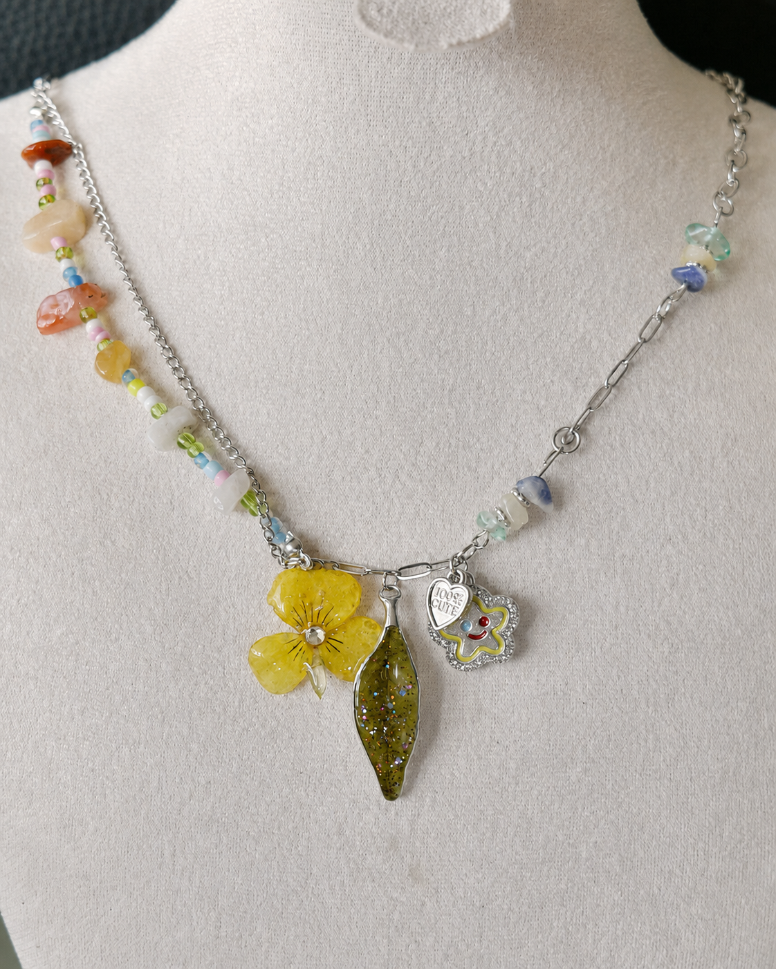Front display view of the Yellow Pansy and Nandina Leaf Y2K Charm Necklace, Yellow Pansy & Nandina Leaf Y2K Charm Necklace botanical jewellery by Terra Decode