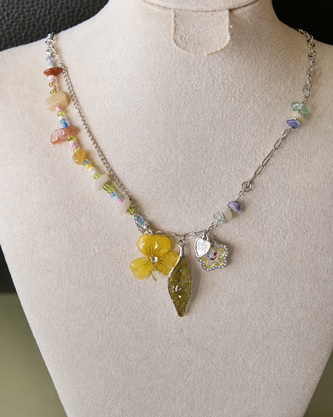 Angled view of the preserved yellow pansy, Nandina leaf and colourful natural-stone beads, Yellow Pansy & Nandina Leaf Y2K Charm Necklace botanical jewellery by Terra Decode