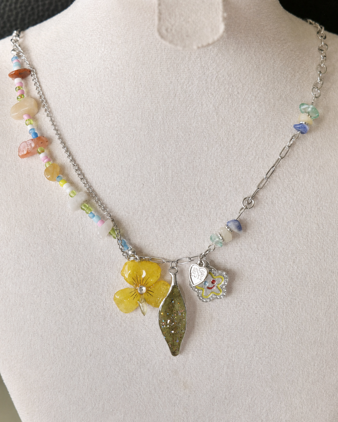 Detailed display of the botanical charm necklace with mixed silver-toned chain, Yellow Pansy & Nandina Leaf Y2K Charm Necklace botanical jewellery by Terra Decode